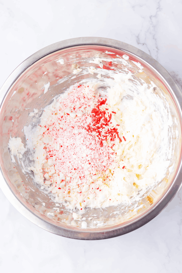 Adding crushed peppermints and red food coloring to Valentine’s Day fluff