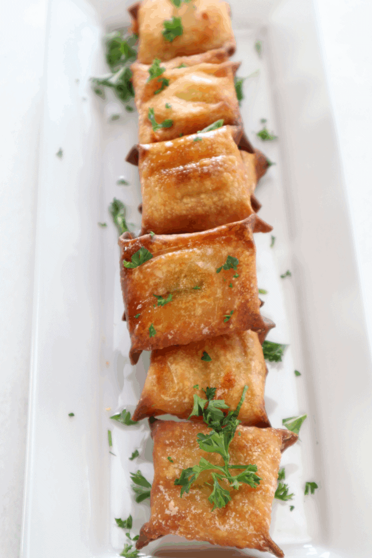 Golden crispy air fryer wontons filled with melted cheese and tangy pickles
