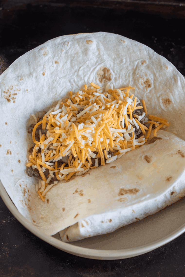 Seasoned Blackstone griddle taco meat with seared edges, piled high on the griddle