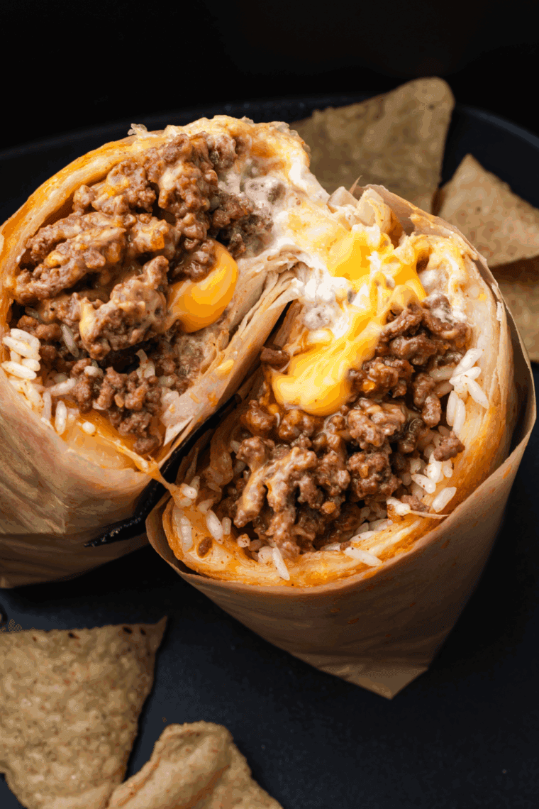 Finished taco meat served with warm tortillas, shredded cheese, lettuce, and salsa