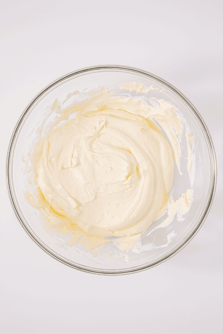 Whisking instant vanilla pudding and whole milk in a glass bowl until smooth and creamy