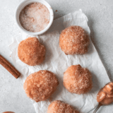 A plate of golden, fluffy homemade First Watch-style holey donuts ready to serve.
