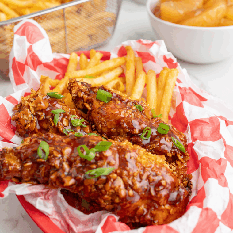 Easy Hot Honey BBQ Sauce made with honey, barbecue sauce, and spices in a saucepan ready for glazing chicken or ribs