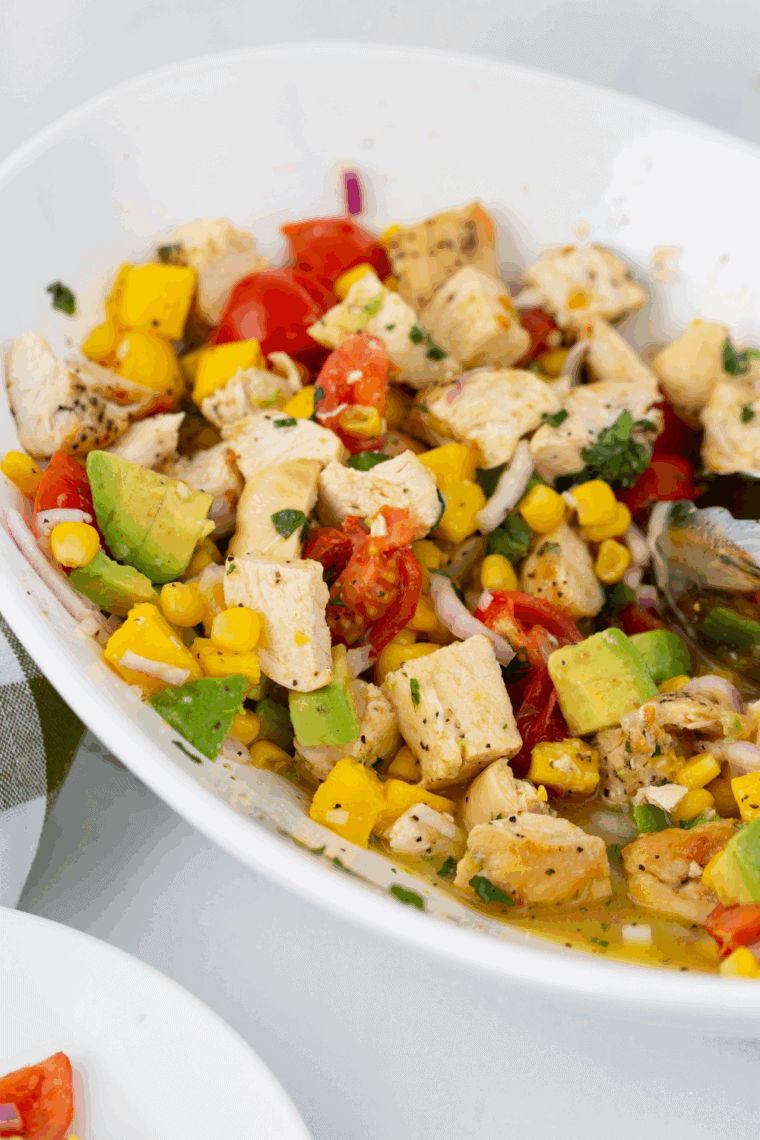 Fresh homemade mango salad dressing in a bowl with ripe mango pieces
