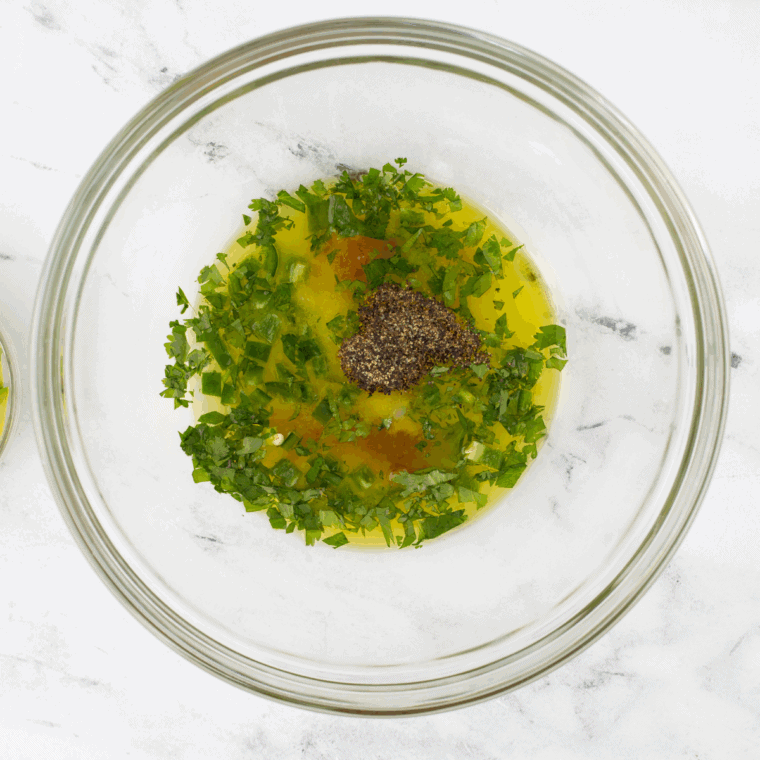 Blending fresh mango, olive oil, lime juice, and seasonings into smooth dressing