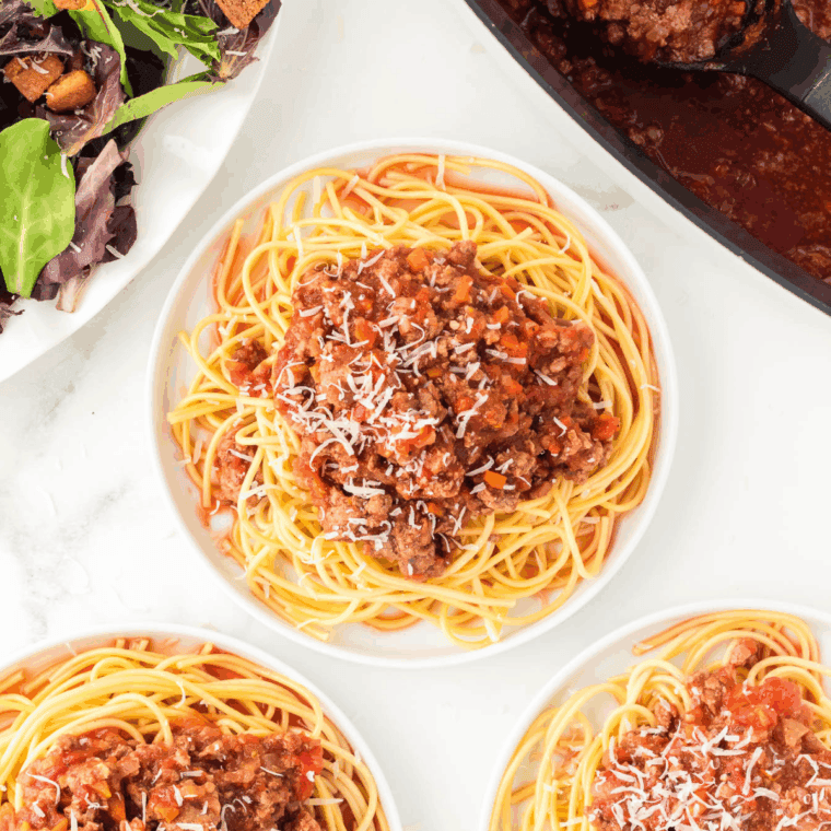 Serving homemade bolognese sauce over pasta for dinner