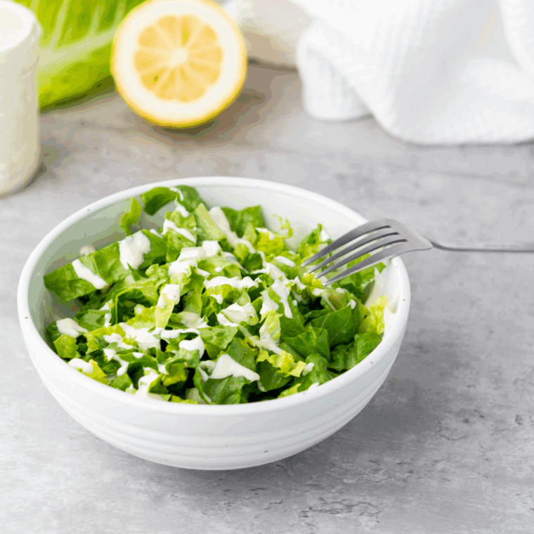 Easy spicy Caesar dressing made at home on top of a salad.