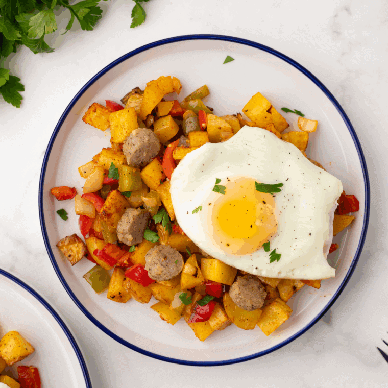 First Watch copycat market hash with crispy potatoes, chicken, vegetables, and melted cheese served in a skillet