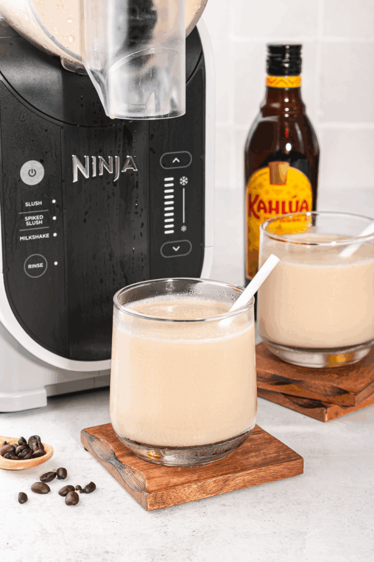 Ninja Slushi Frozen White Russian in a glass, creamy and icy with a swirl of Kahlúa and vodka.