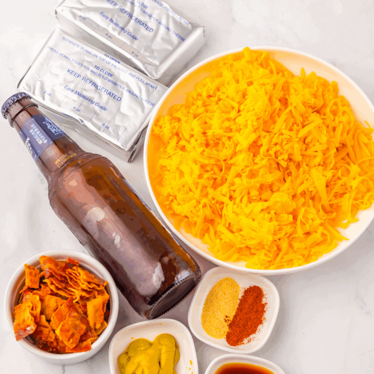 Ingredients needed for Easy Slow Cooker Beer Cheese Dip on kitchen table.