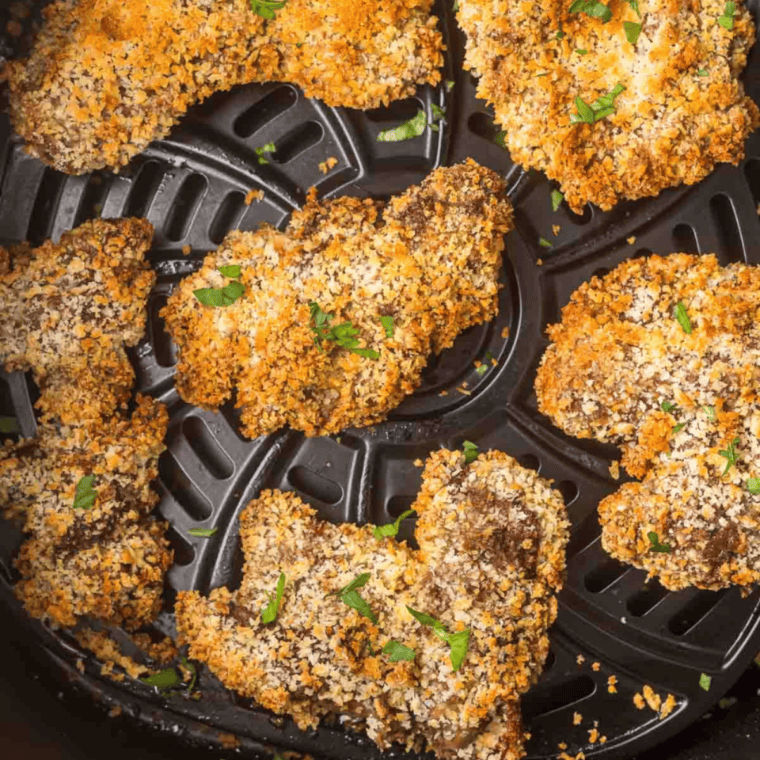 Golden, crispy breaded chicken livers fresh from the air fryer on a serving plate.