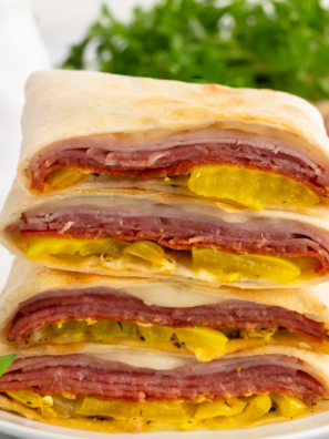 Air Fryer Hot Italian Wraps with melted cheese, Italian meats, and crispy golden tortilla on a plate.