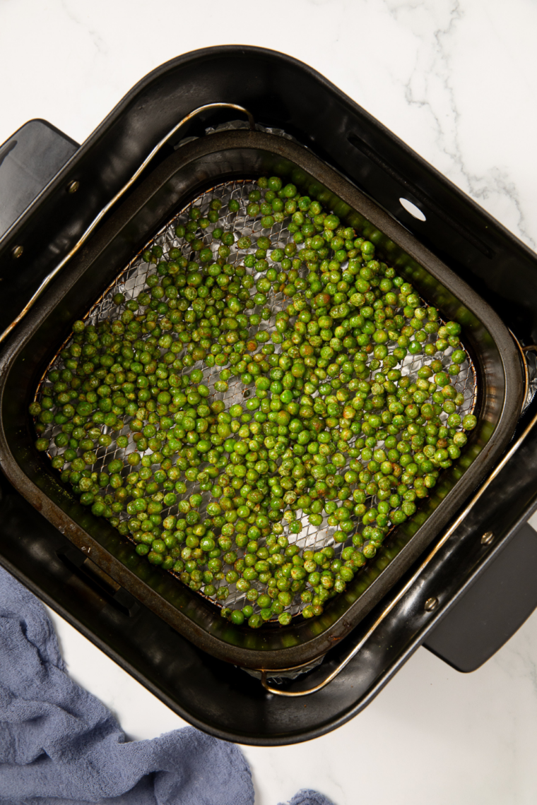 Crispy air fryer wasabi peas served in a bowl, coated with spicy seasoning