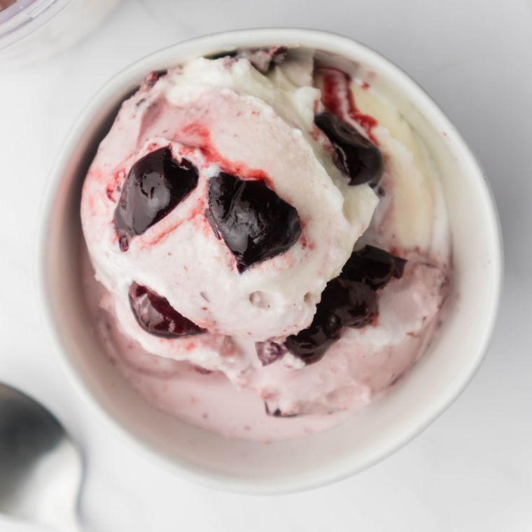 Smooth and creamy cherry gelato served in a bowl, topped with fresh cherries.