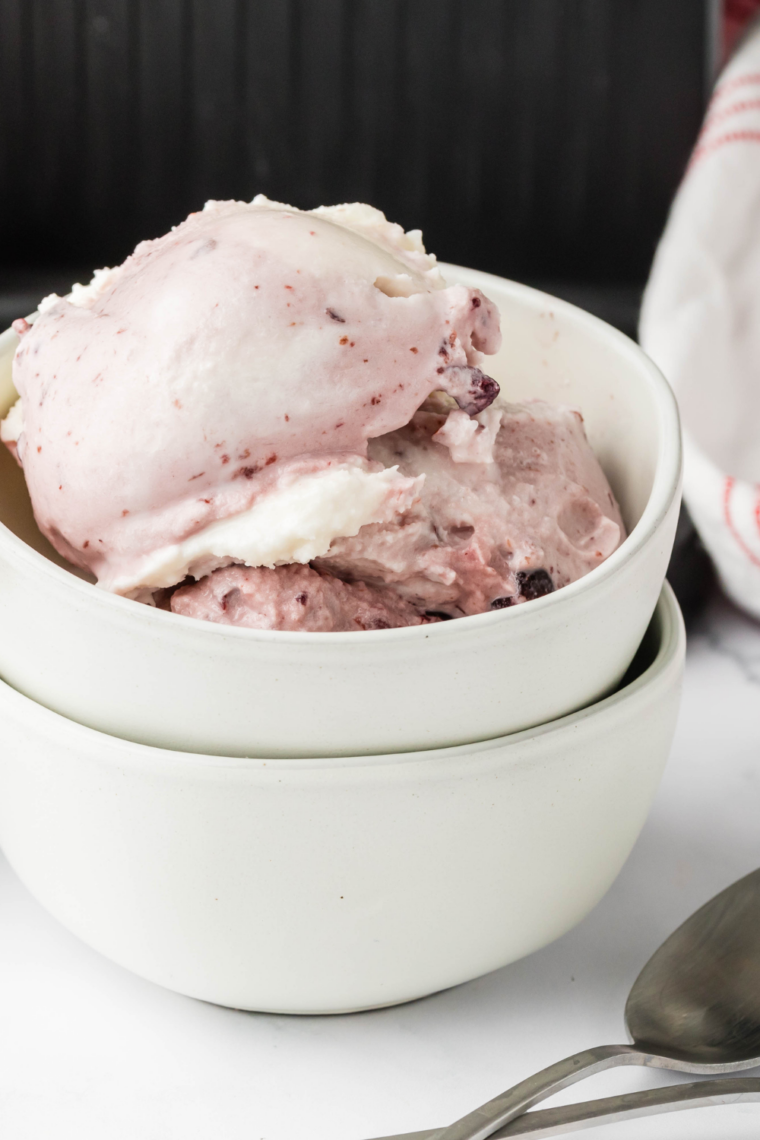 Step-by-step Ninja Creami cherry gelato: blended milk, cream, and vanilla mix with cherries, frozen, churned, and served creamy in a bowl.