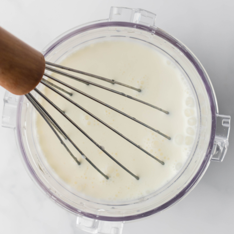 Mixing milk, heavy cream, sugar, lemon juice, lemon zest, and vanilla ice cream mix in a bowl until smooth.