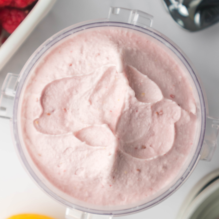 Finished creamy lemon raspberry gelato served in a bowl with visible raspberry swirl