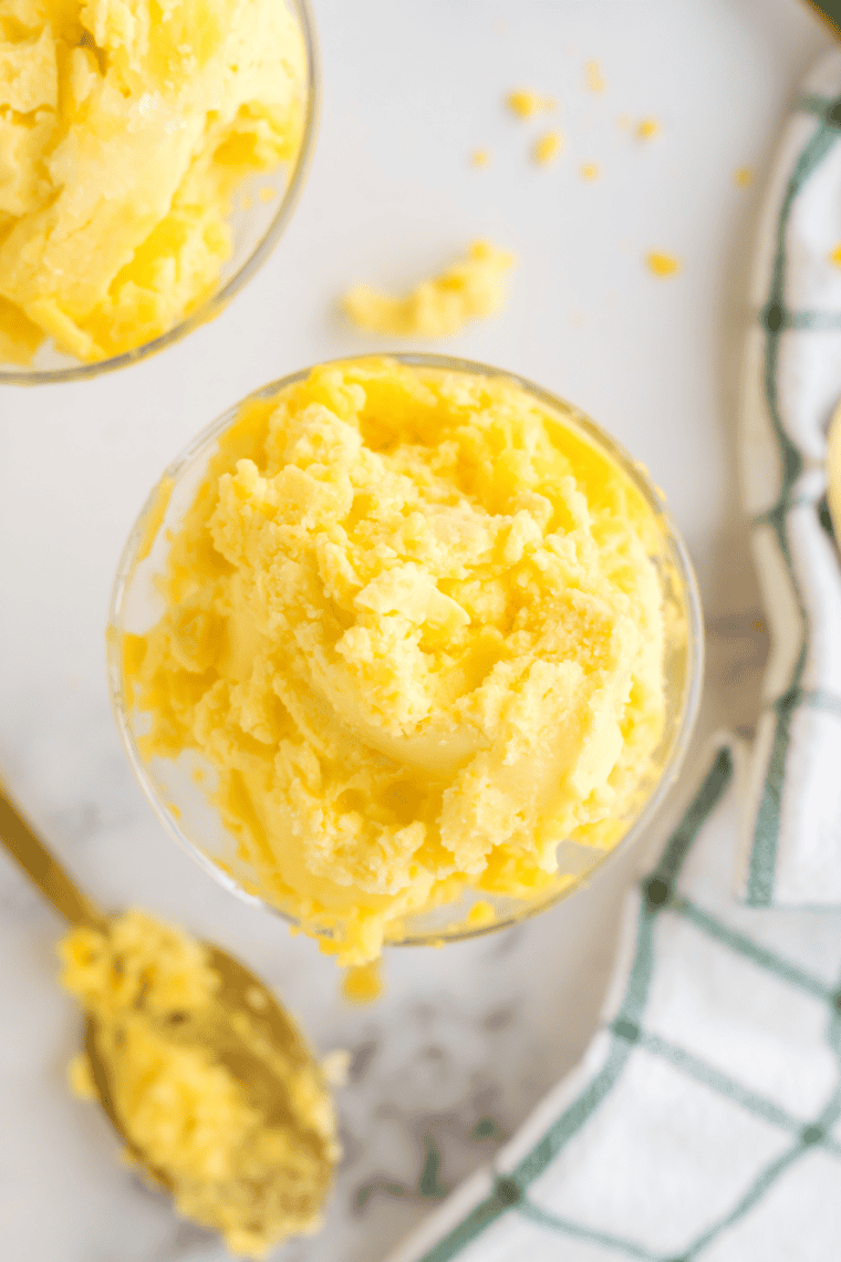 Bowl of creamy Easy Ninja Creami Mango Gelato garnished with fresh mango pieces, ready to serve.