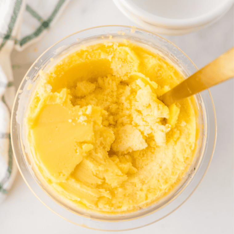 Scoops of creamy Ninja Creami Mango Gelato in bowls garnished with fresh mango chunks.