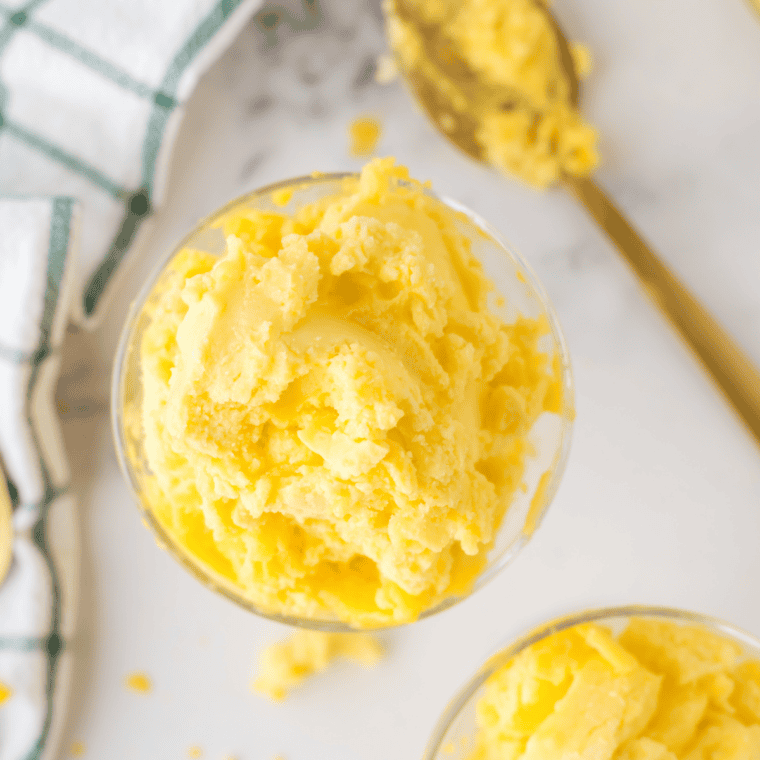 Bowl of creamy Ninja Creami Mango Gelato topped with fresh mango chunks, ready to serve.