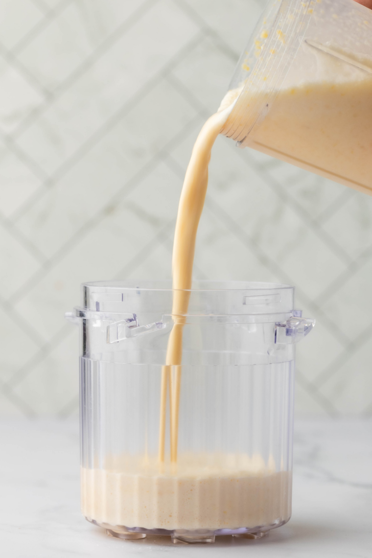 Peach gelato base poured into Ninja Creami pint container before freezing