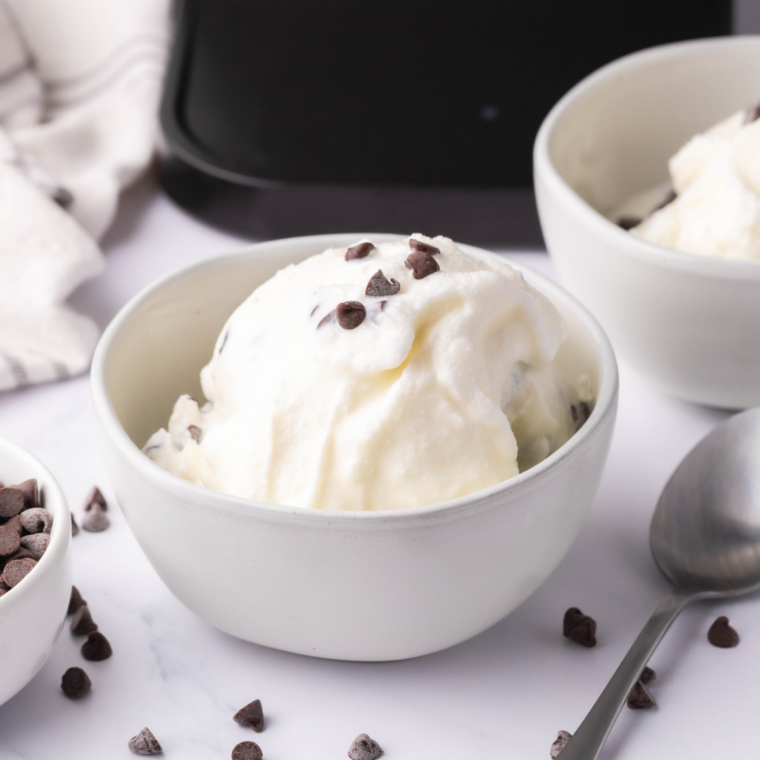 Bowl of creamy Ninja Creami stracciatella gelato with chocolate flakes throughout, ready to serve.