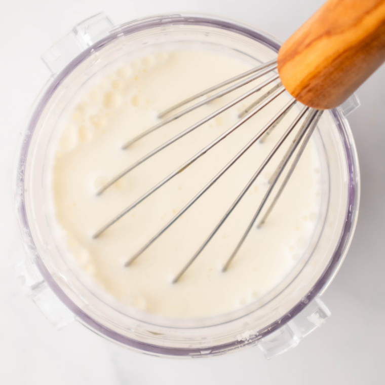 Whisking milk, cream, sugar, and vanilla mix in Ninja Creami pint until smooth.