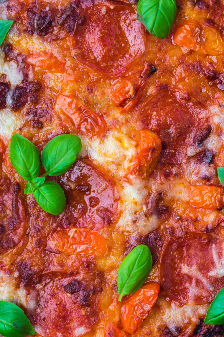 Bake on Ninja Woodfire Grill – pizza cooking on Ninja Woodfire Grill until golden and bubbly.