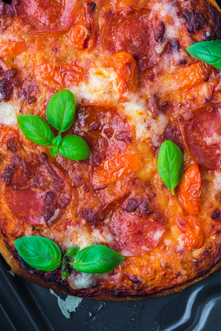 Serve and Enjoy – freshly baked woodfire-style pizza sliced and ready to serve.