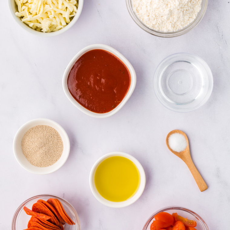 Ingredients needed for Easy Ninja Woodfire Pizza Recipe on kitchen table.