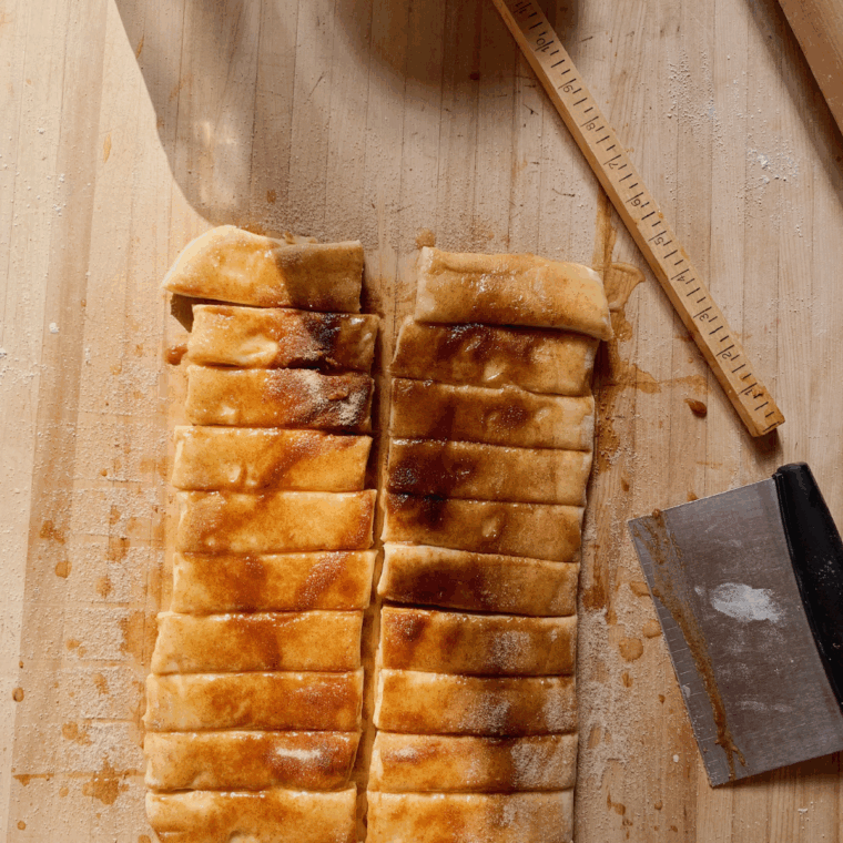Cinnamon sugar mixture sprinkled over buttered puff pastry