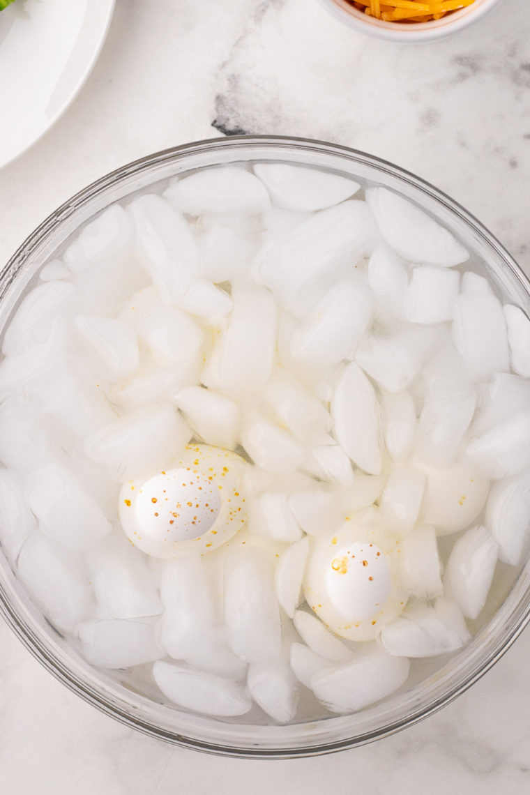 Cool the Eggs: Hard-boiled eggs in ice water to stop cooking and make peeling easier.