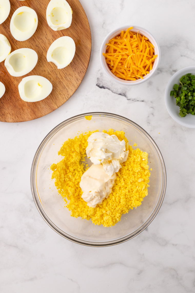 Make the Filling: Egg yolks mashed with mayonnaise, mustard, vinegar, salt, and pepper until smooth.