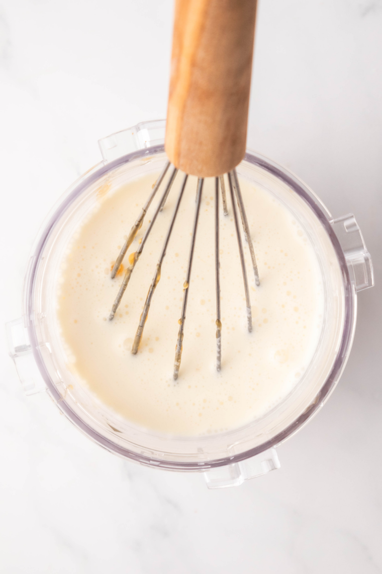 Whisking milk, cream, caramel, sugar, and vanilla in Ninja Creami pint container