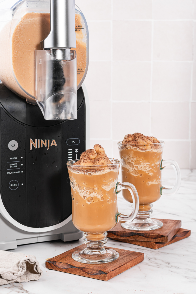 Creamy frozen Irish coffee slush blended in a Ninja Slushi machine, topped with whipped cream and served in a chilled glass.