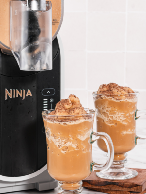 Frozen Irish coffee slush made in a Ninja Slushi machine, topped with whipped cream and served in a clear glass.