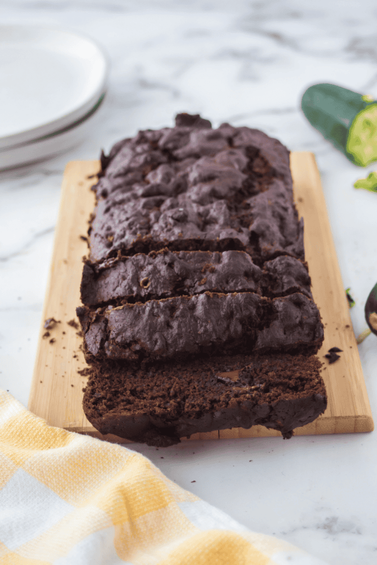 Slice of moist chocolate chip zucchini bread fresh from the air fryer, golden brown and loaded with chocolate chips.