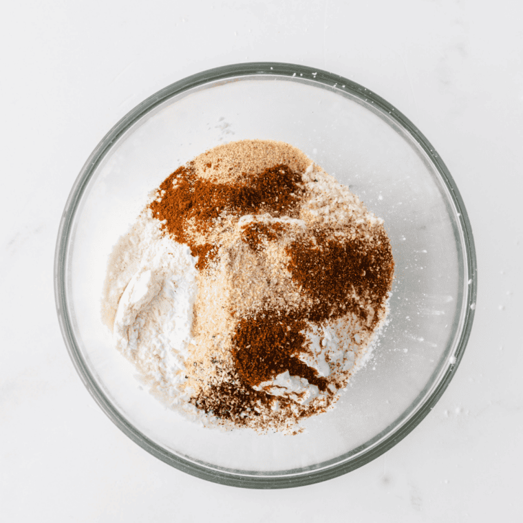 Mixing brown sugar, smoked paprika, kosher salt, black pepper, garlic powder, onion powder, chili powder, cayenne, and dried thyme in a medium bowl.