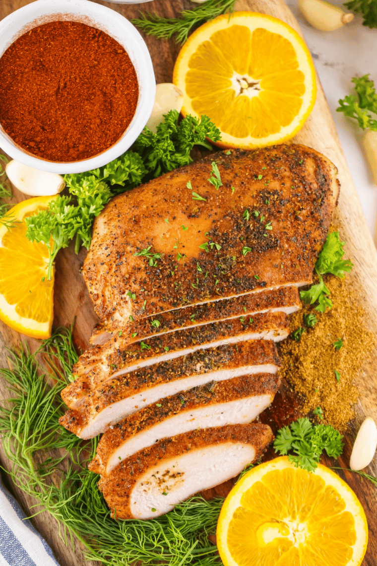 Jar of Copycat Kinder’s Hickory Brown Sugar Rub & Seasoning with a small bowl of spice mixture ready for cooking.