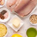 Homemade copycat Kinder’s honey mustard seasoning blend in a small bowl with spices on a wooden surface.