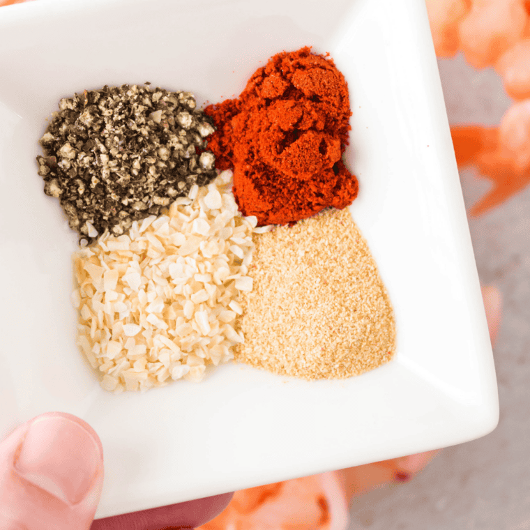 Measuring honey powder, mustard powder, garlic powder, and spices for homemade honey mustard seasoning.