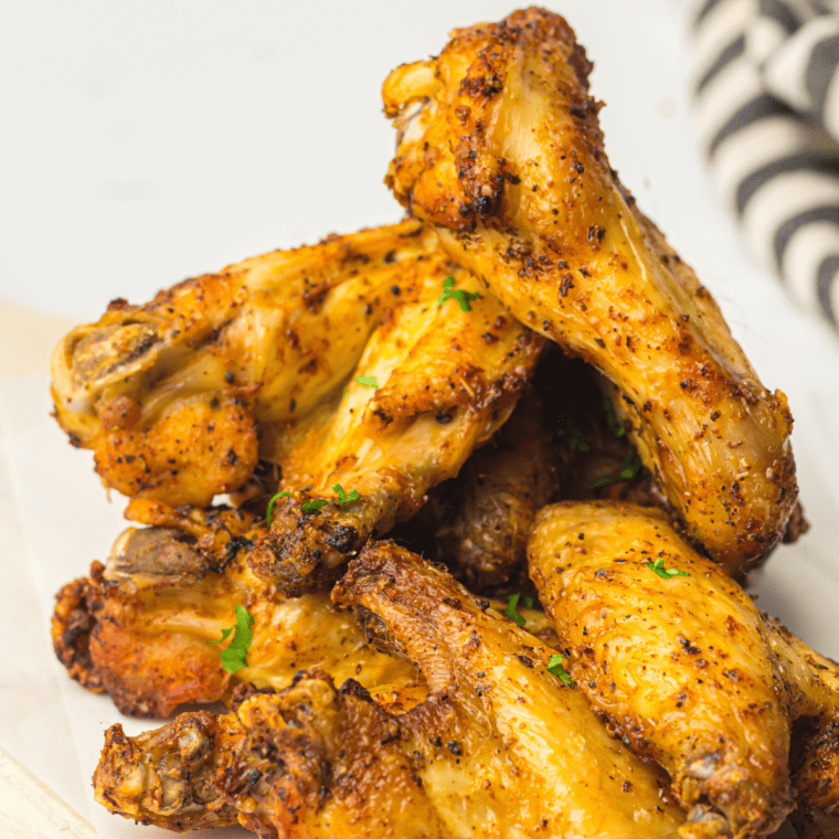 Hands stirring the dried herbs and spices together until smooth, evenly blended Greek seasoning.