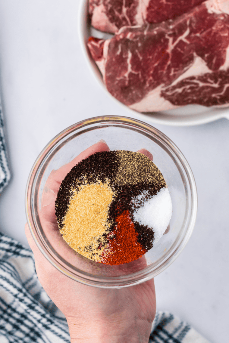 Small bowl with measured spices for Copycat Kinder’s The Steak Blend being combined