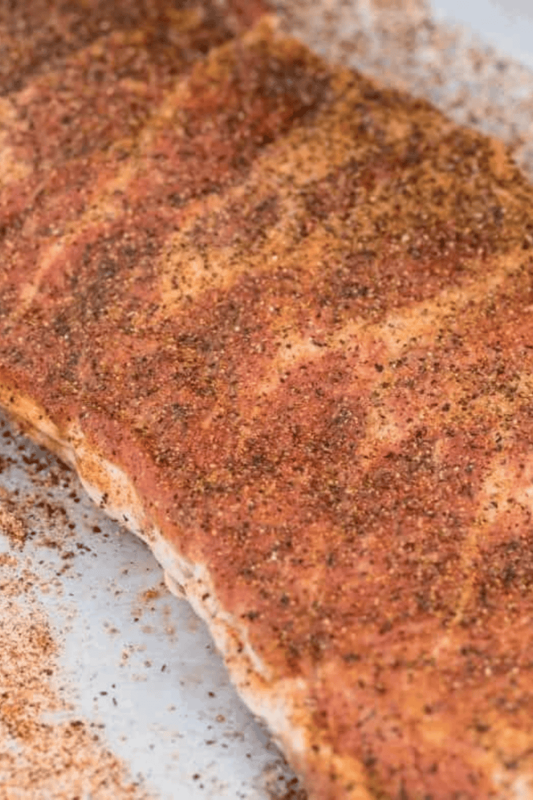 Homemade Kinder’s The Steak Blend being whisked and sprinkled over steaks, burgers, and vegetables