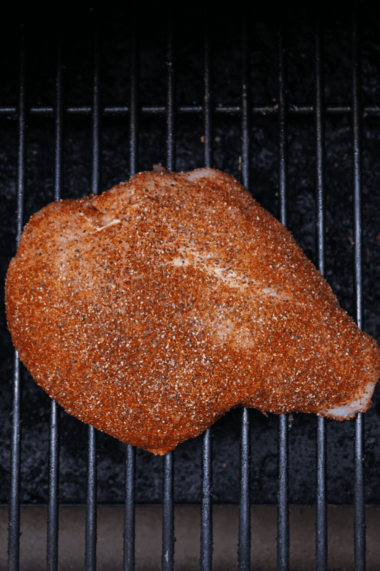 Preheating smoker to 225°F with hickory or applewood chips.