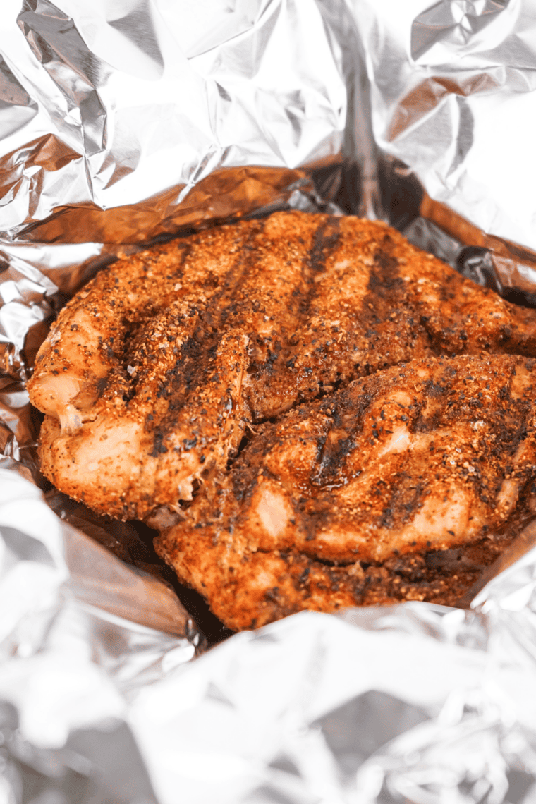Smoking seasoned turkey breast until internal temperature reaches 165°F.