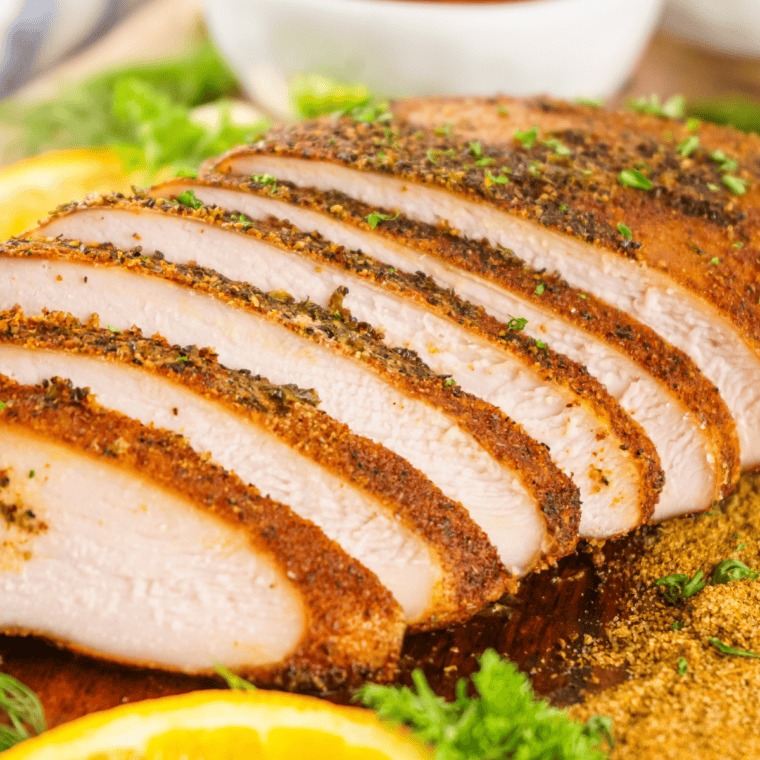 Slicing juicy Cajun smoked turkey breast against the grain to serve.