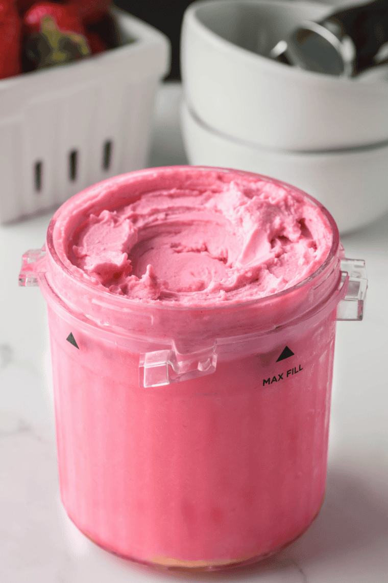 Bright pink Ninja Creami copycat bubble gum ice cream with candy pieces served in a bowl.