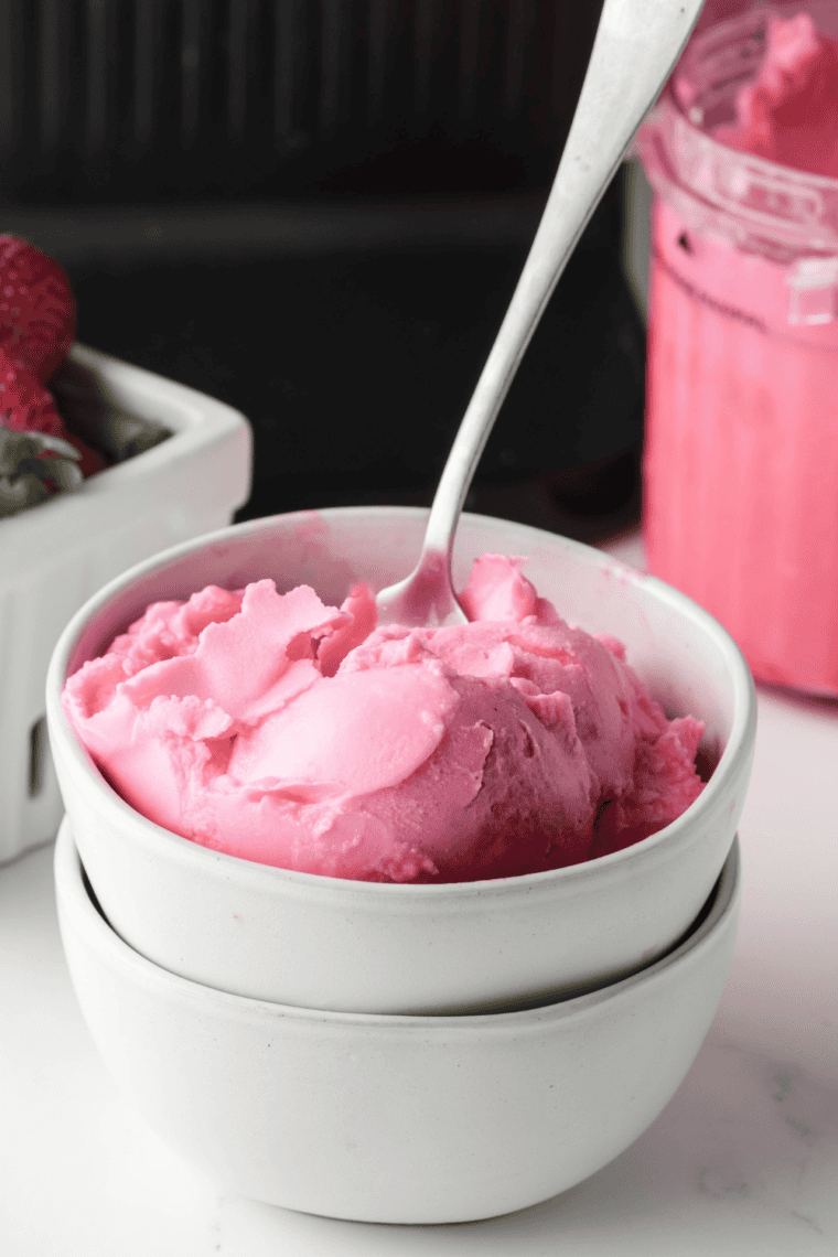 Creamy Ninja Creami Baskin Robbins copycat bubble gum ice cream with pink color and candy pieces served in a bowl.