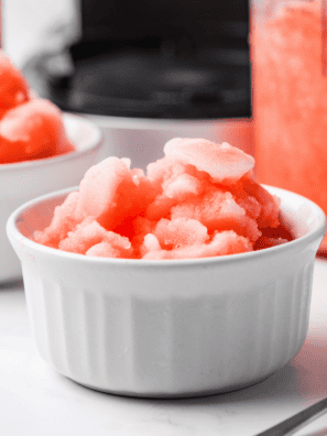 Bright red cherry Italian ice scooped into a glass bowl, smooth icy texture made in the Ninja Creami.